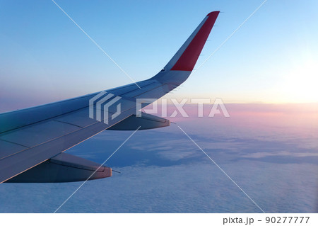 Wing of an airplane. Travel tourism air transportation concept. Selective focus Wing of an airplane. Travel tourism air transportation concept. Selective focus 90277777