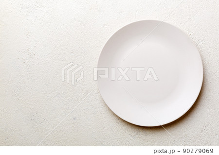 Top view of empty light plate on cement background. Empty space for your design 90279069
