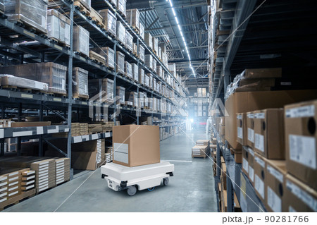 Mobile robot transporting a box in a warehouse Mobile robot transporting a box in a warehouse 90281766