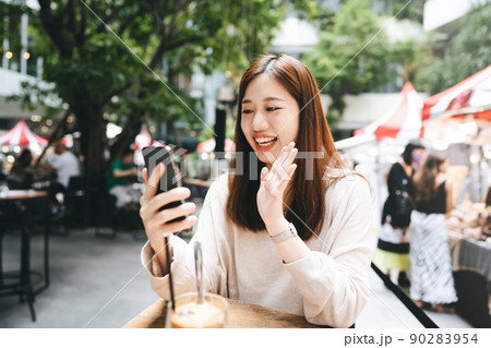 Young adult business asian woman use tablet for business at outdoor cafe 90283954