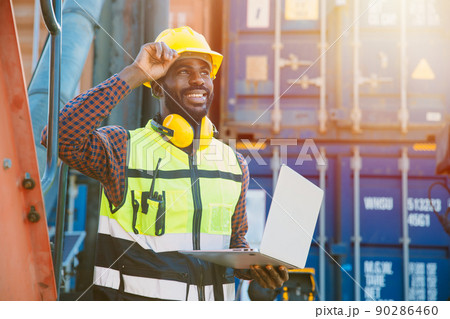 black worker African working engineer foreman in port cargo shipping with computer laptop 90286460