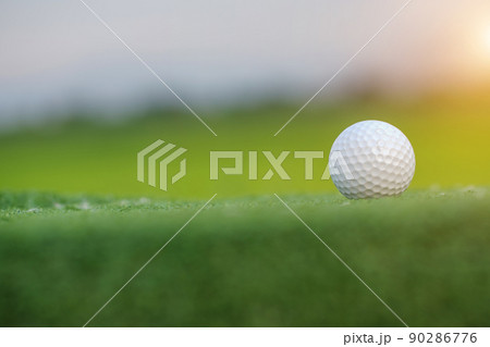 Golf ball on Green field golf course in morning time with soft sunlight. Golf ball on Green field golf course in morning time with soft sunlight. 90286776