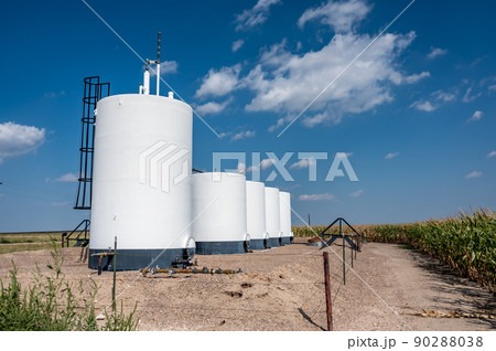 crude oil storage tanks with secondary containment and fencing in a rural corn field crude oil storage tanks with secondary containment and fencing in a rural corn field 90288038