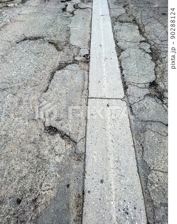 Pot hole and cracks in a road caused by heavy industrial loads Pot hole and cracks in a road caused by heavy industrial loads 90288124