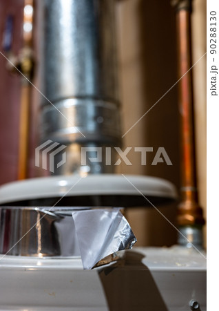 selective focus on the edge of a roll of metallic aluminum foil HVAC duct tape 90288130