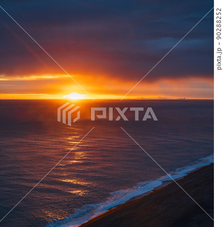 Picturesque autumn evening view to endless ocean  black volcanic sand beach from Dyrholaey Cape, Vik, South Iceland. Vestmannaeyjar islands weird silhouettes on horizont. 90288252
