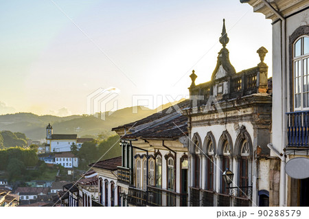 View of colonial style houses facade and historic baroque church in Ouro Preto View of colonial style houses facade and historic baroque church in Ouro Preto 90288579