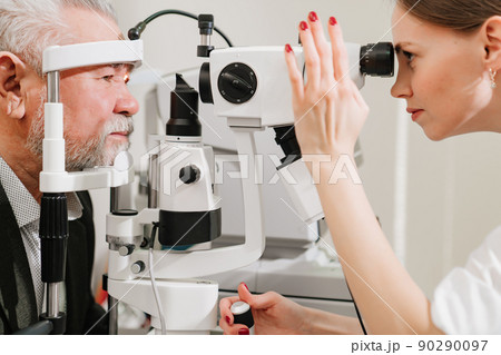 ophthalmologist examination of elderly man with slit lamp. medical equipment ophthalmologist examination of elderly man with slit lamp. medical equipment 90290097
