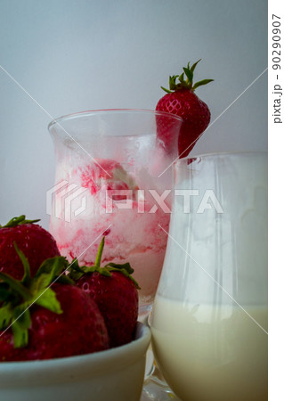 Strawberry ice cream with blurried strawberry and Milk on a foreground. High quality photo Strawberry ice cream with blurried strawberry and Milk on a foreground. High quality photo 90290907