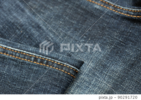 Detailed abstract texture of dark blue denim cloth. Background image of old used denim trousers fabric Detailed abstract texture of dark blue denim cloth. Background image of old used denim trousers fabric 90291720
