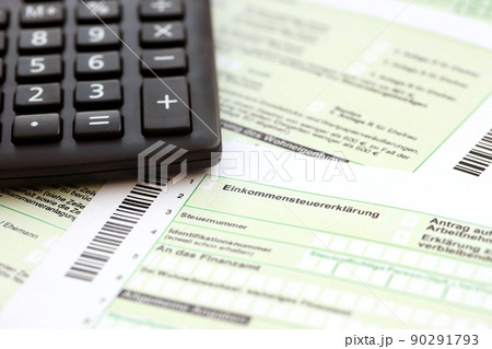 German annual income tax return declaration and calculator lies on accountant table close up. The concept of taxpaying period in Germany 90291793