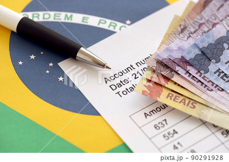 Pen with Brazilian money bills on blank of lottery game. Concept of luck and gambling in Brazil Pen with Brazilian money bills on blank of lottery game. Concept of luck and gambling in Brazil 90291928