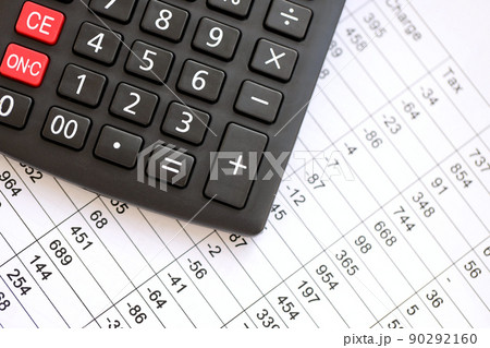 Big black calculator lies on financial statement and balance sheeet on desk of auditor close up. Concept of accounting and audit business. Taxpaying Big black calculator lies on financial statement and balance sheeet on desk of auditor close up. Concept of accounting and audit business. Taxpaying 90292160