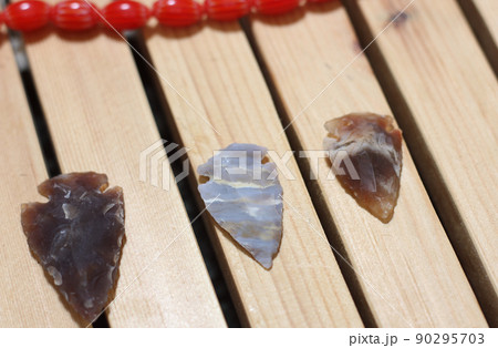 Native American Arrowhead Collection on Wooden Background Native American Arrowhead Collection on Wooden Background 90295703