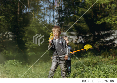 little boys with butterfly nets in countryside. Image with selective focus little boys with butterfly nets in countryside. Image with selective focus 90298180