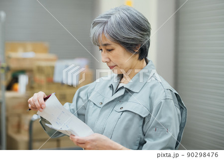 倉庫で棚卸しする作業員のシニアビジネスウーマン 倉庫で棚卸しする作業員のシニアビジネスウーマン 90298476