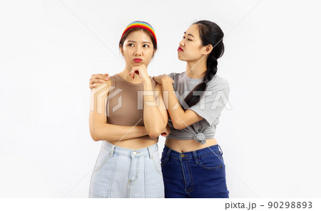Photo of Young asian women in concept of lgbt couple isolated on white wall background. 90298893