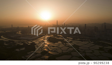 Shenzhen skyline , with skyscrapers and office against fish farm or fish ponds, during dramatic moment in evening, from the view of boundary of Hong Kong suburb where is named Ma Tao Lung Shenzhen skyline , with skyscrapers and office against fish farm or fish ponds, during dramatic moment in evening, from the view of boundary of Hong Kong suburb where is named Ma Tao Lung 90299238