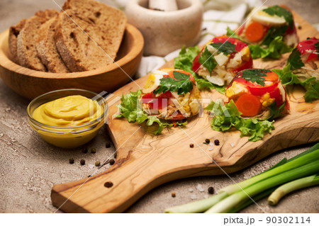 Portion of delicious chicken aspic on serving board on concrete table 90302114