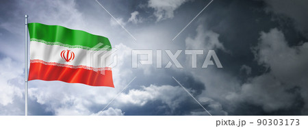 Iranian flag on a cloudy sky 90303173