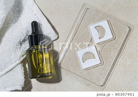 Cosmetic Microneedle eye Patches  and bottle of serum or oil for daily routine before bed 90307401