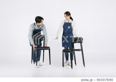 Asian Korean young man and woman startup concept_ tidying up their chairs 90307690