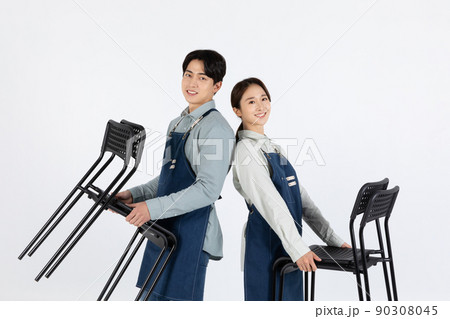 Asian Korean young man and woman startup concept_ tidying up their chairs Asian Korean young man and woman startup concept_ tidying up their chairs 90308045