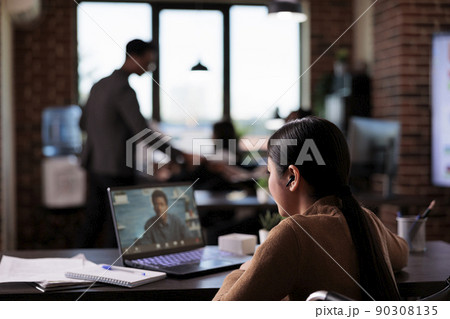 Woman with chronic disability talking on online videocall, meeting with man on internet teleconference. Female wheelchair user with health condition using remote videoconference telework chat. 90308135