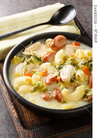 Chicken Sopas or Chicken Macaroni Soup Filipino Style close-up on a plate on the table. Vertical Chicken Sopas or Chicken Macaroni Soup Filipino Style close-up on a plate on the table. Vertical 90308445