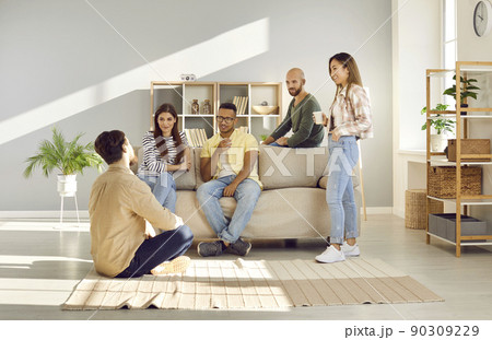 Smiling diverse employees talk at coffee break in office 90309229