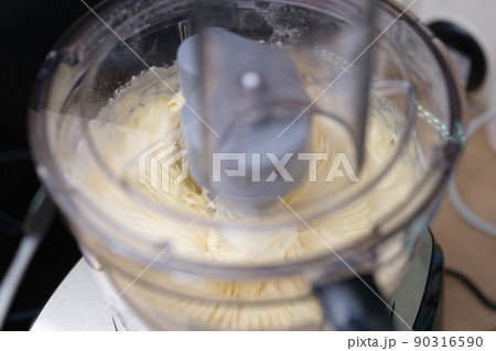 Mixer beats dough or cream for baking closeup Mixer beats dough or cream for baking closeup 90316590