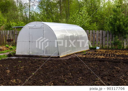 greenhouse in the garden. Polycarbonate greenhouse. Spring 90317706