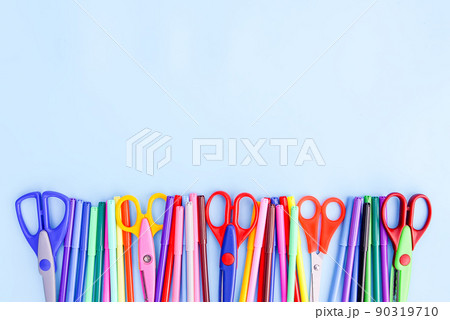School supplies. Back to School design elements. Colorful markers and scissors on light blue paper background. School supplies. Back to School design elements. Colorful markers and scissors on light blue paper background. 90319710