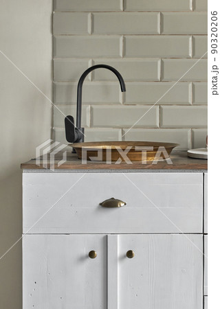 White cabinets with copper sink at kitchen counter residential house. White cabinets with copper sink at kitchen counter residential house. 90320206