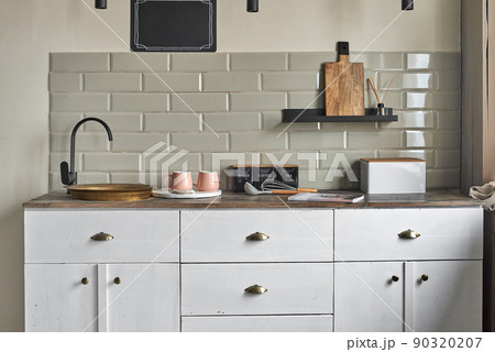 Elegant small kitchen with sink and counter at country house. 90320207