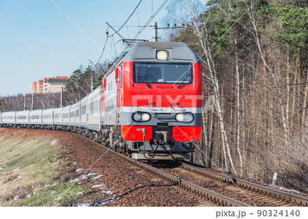Passenger train moves at spring morning time. Passenger train moves at spring morning time. 90324140