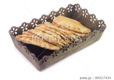 Pita bread isolated on white background in the breakfast basket. Traditional food of Arabic cuisine 90327434