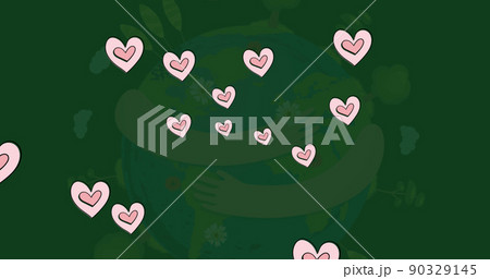 Image of hearts floating over hands holding globe on green background 90329145