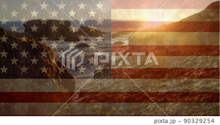 Rocky mountains near ocean against US flag 90329254