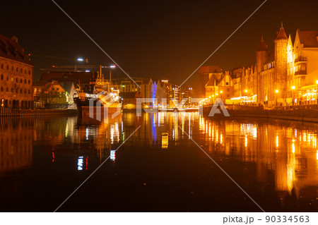 Old town in Gdansk at night. The riverside on Granary Island reflection in Moltawa River Cityscape at twilight. Ancient crane at dusk. Visit Gdansk Poland Travel destination 90334563