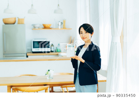 電卓を持つ不動産業のミドルのビジネスウーマン　 90335450