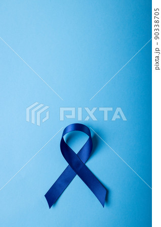 Close-up of blue stomach cancer awareness ribbon on blue background, copy space Close-up of blue stomach cancer awareness ribbon on blue background, copy space 90338705