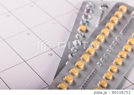 High angle close-up of medicine blister packs on medication calendar, copy space High angle close-up of medicine blister packs on medication calendar, copy space 90338752