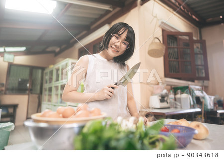 Happy young adult asian woman leisure with cooking in kitchen on day. Happy young adult asian woman leisure with cooking in kitchen on day. 90343618