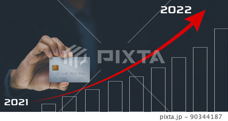 Businessman hand holding credit visa card and red arrow 2021-2022 on the background, online payment, shopping online, e-commerce, internet banking, spending money concept, debt spending, loss business 90344187