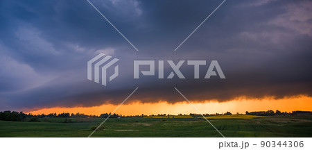 Storm cloud in the sunset light, shelf cloud with dramatic light Storm cloud in the sunset light, shelf cloud with dramatic light 90344306