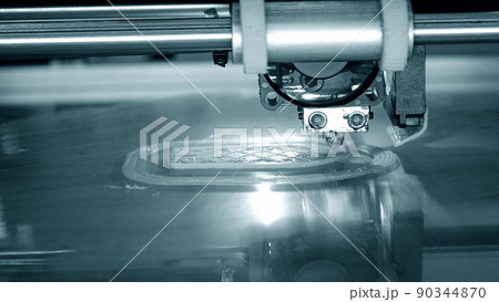 3D printer works and creates an object from hot molten plastic close-up. Automatic three dimensional 3d printer performs plastic blue colors modeling in laboratory. 3D printer works and creates an object from hot molten plastic close-up. Automatic three dimensional 3d printer performs plastic blue colors modeling in laboratory. 90344870