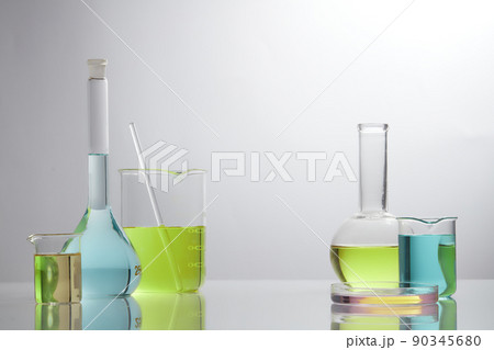 Front view of laboratory equipment filled with colorful fluid in a beaker test tube in lab background for experiment advertising 90345680