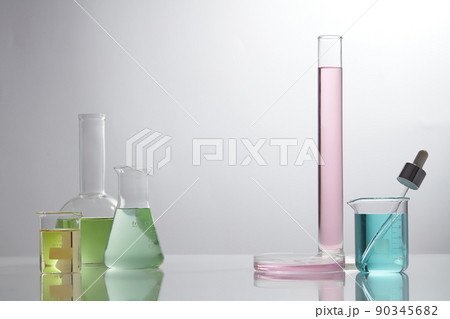 Front view of laboratory equipment filled with colorful fluid in a beaker test tube in lab background for experiment advertising 90345682