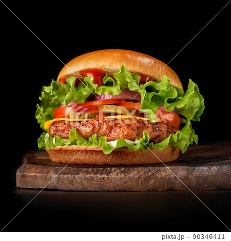 Delicious burgers with beef, tomato, cheese and lettuce 90346411